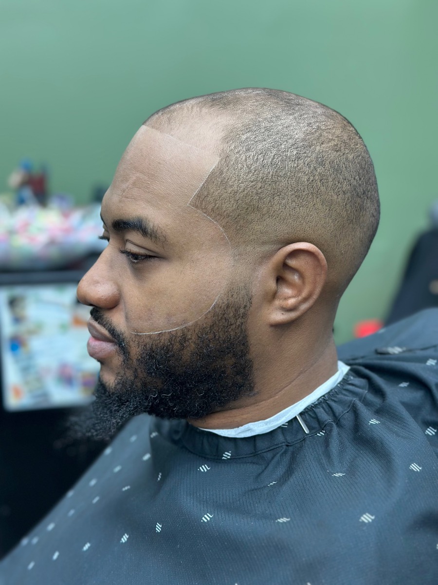 Fresh skin fade with sharp beard lineup at Rebirth Barbershop
