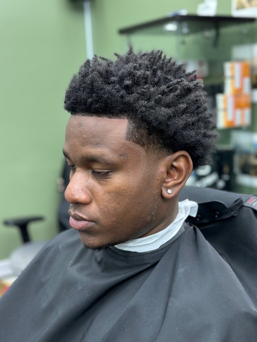 Client with twist sponge cut and crisp lineup at Rebirth Barbershop