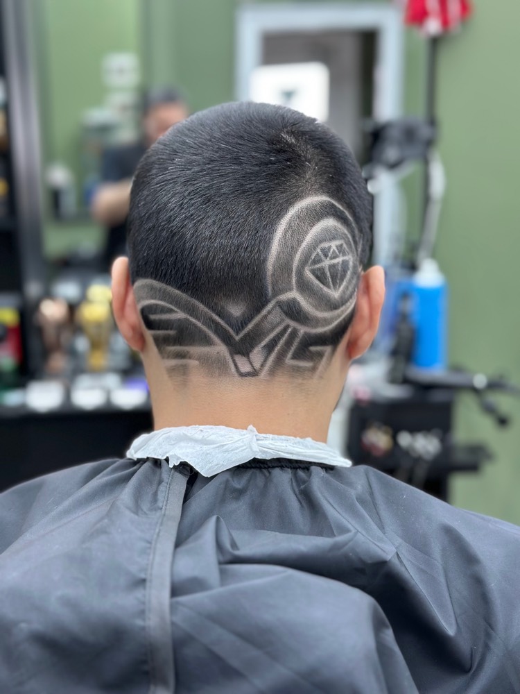 Etched diamond hair design on the side of a drop fade