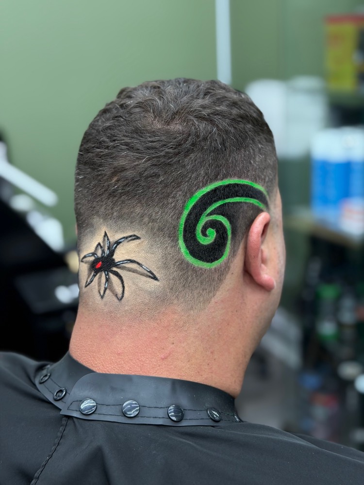 Freestyle colored spider design cut into the back of a fade